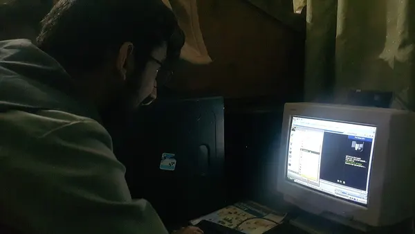 A person working on old desktop computer