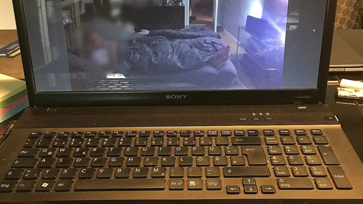 Sony Vaio Laptop showing video with man lying in bed watching TV