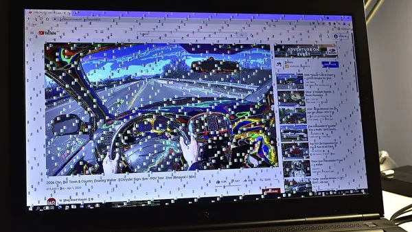 Glitched and garbled display on a workstation laptop with a defective graphics card that underwent extensive overheating from use in a hot environment