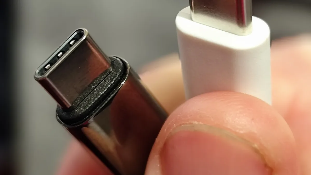 Two USB-C connectors being held