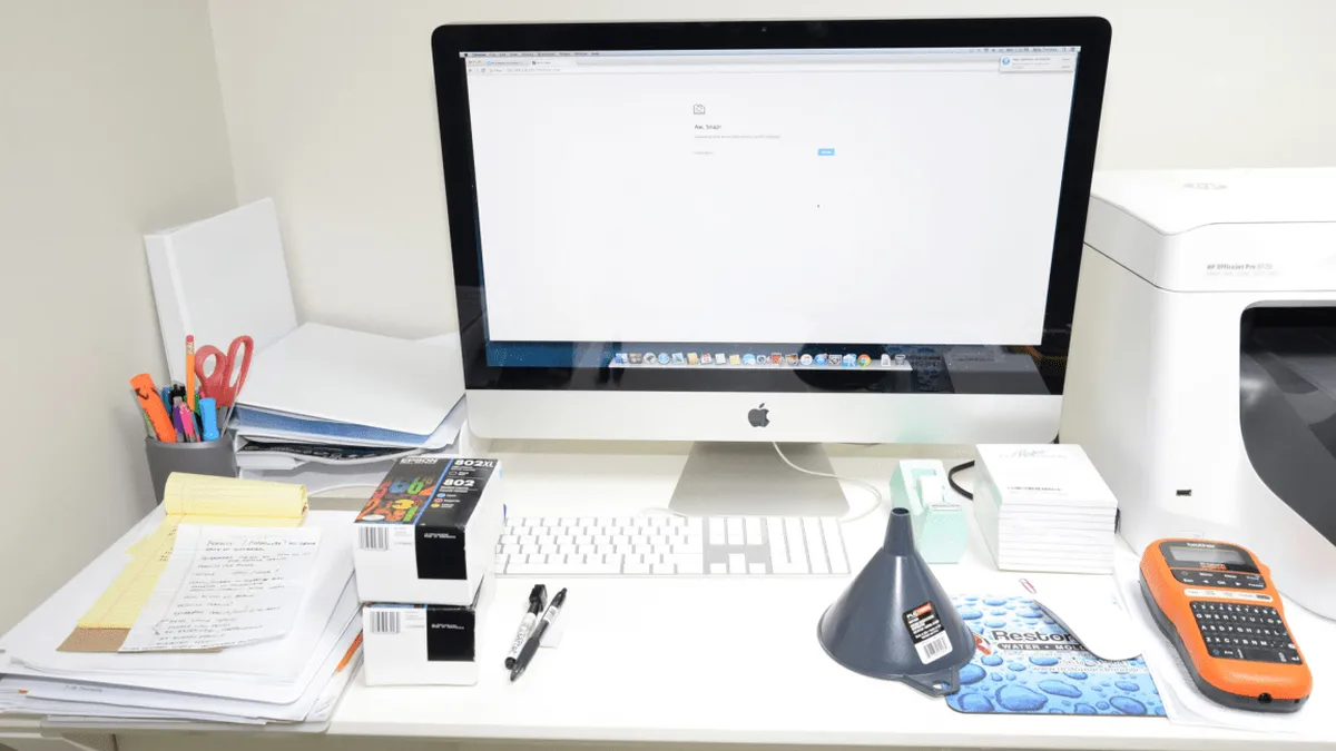 EFTA00002092 - Clean white desk with a computer printer and supplies ready for work