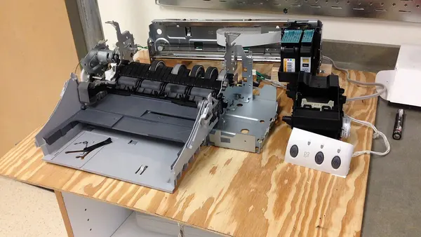 Inkjet printer parts mounted on a plywood board