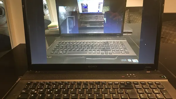 Image with nested realities of laptop showing the same laptop as in previous image in four reality planes