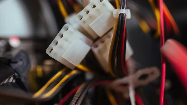Power supply cables are tied together inside a computer case, promoting better airflow and easier maintenance