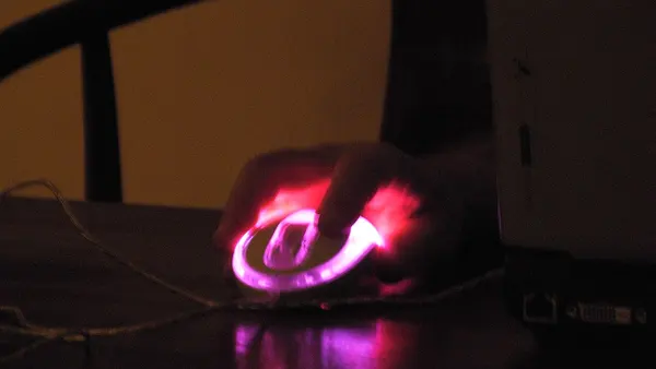 Pink computer mouse in the dark