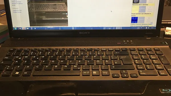 Image with nested realities of a laptop showing a Wikimedia Commons file with the same laptop showing video of man watching TV