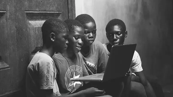 A group of boys using a laptop 04