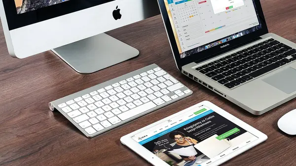 Paperless work desk with an iPad, iMac and a MacBook