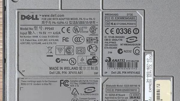 Bottom view of a Dell Latitude D830 showing regulatory labels and service tags