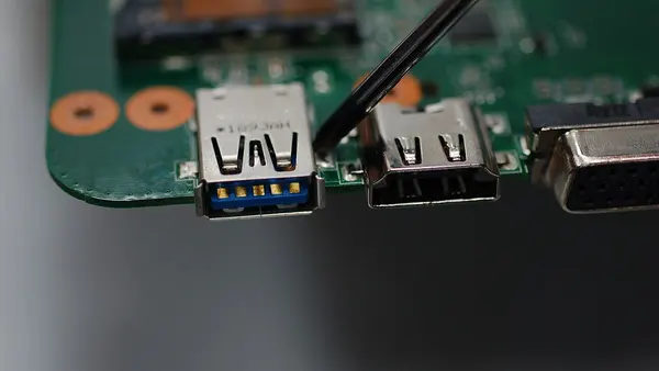 USB port solder points on laptop motherboard