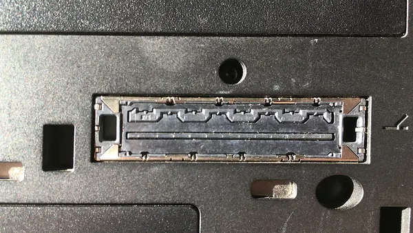 Interface to docking station with metal flaps on lower side of ThinkPad T410 laptop
