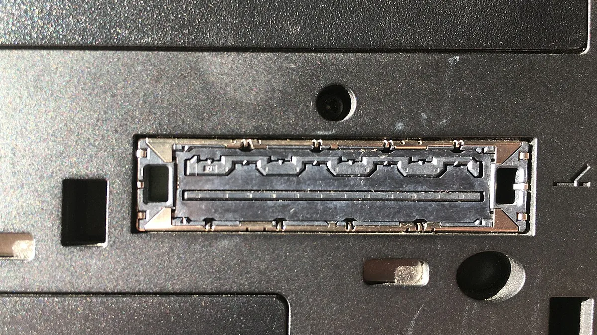 Interface to docking station with metal flaps on lower side of ThinkPad T410 laptop