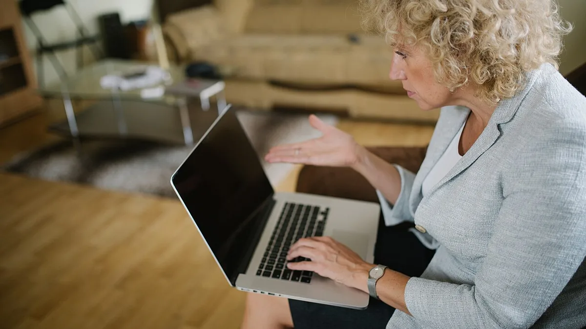 Woman trying to find a problem on her laptop. (51532453865)