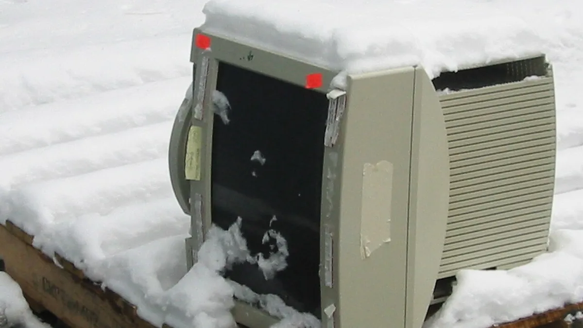 Computer monitor on pallet in snow