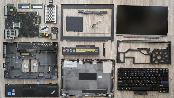 Disassembled Lenovo ThinkPad X220 with components laid out