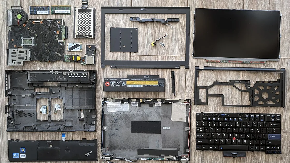 Disassembled Lenovo ThinkPad X220 with components laid out