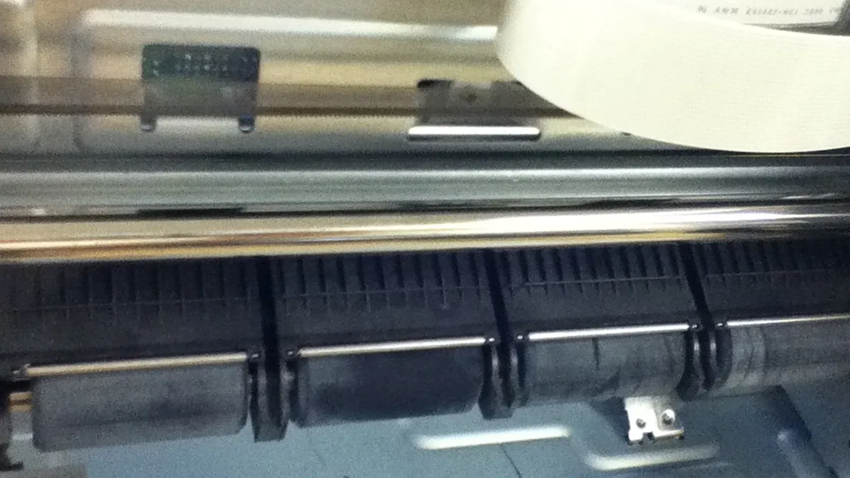 Inkjet paper rollers with plastic guides intact