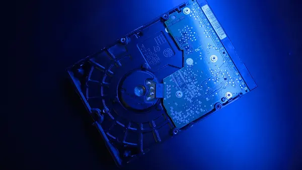 Computer hard disk drives with blue neon light from above
